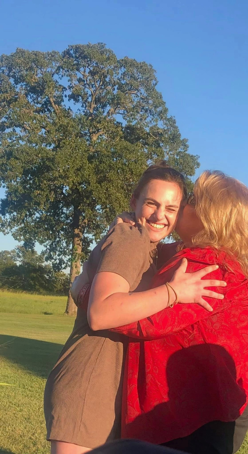 Gracey sharing a joyful embrace outdoors